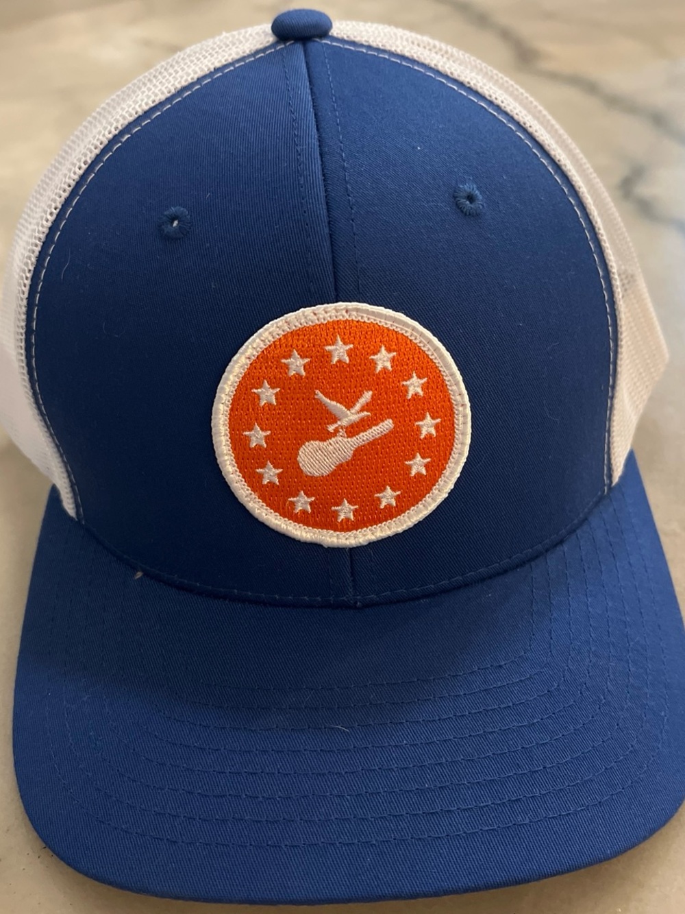The Classic Blue & White Trucker Hat with Orange Guitar Patch